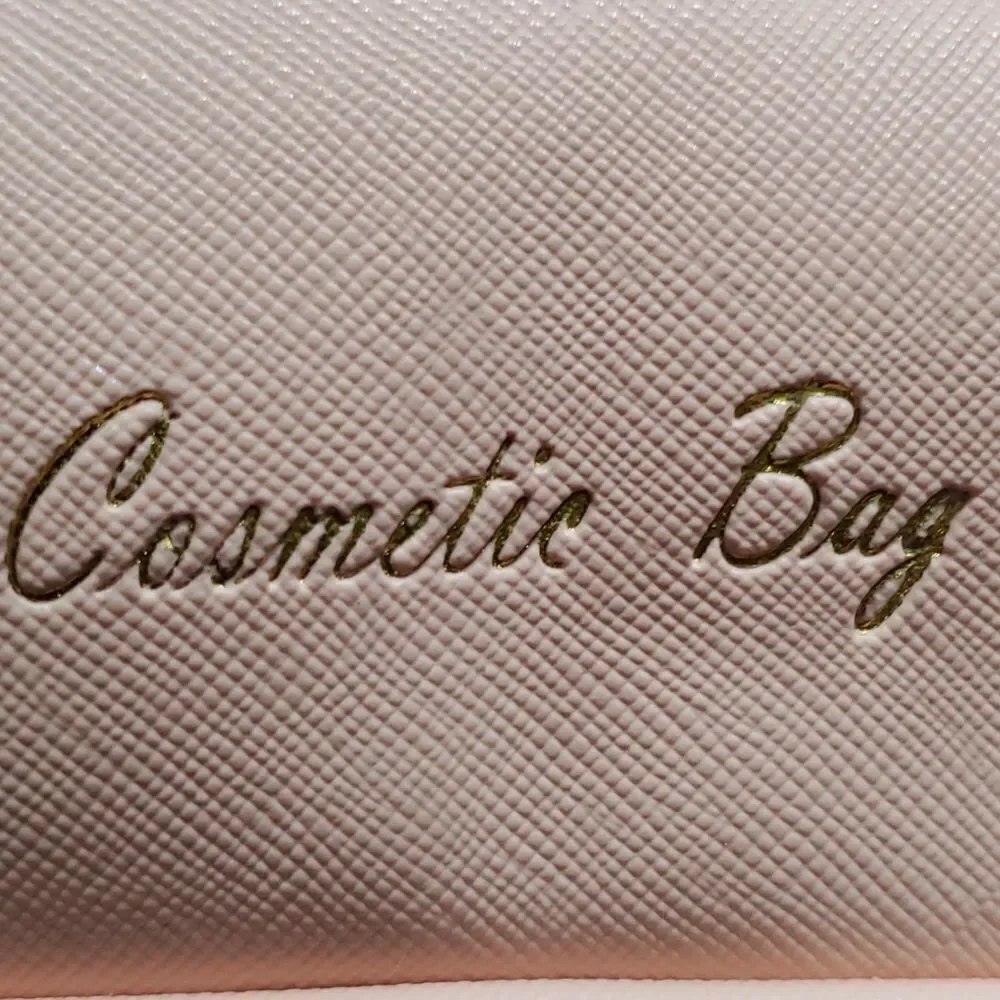 Two cosmetic bags.‎ One in vintage and homemade. The other is pink and la…